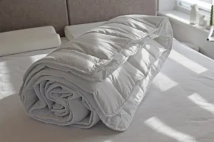 Біла ковдра на ліжку