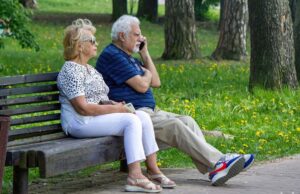 пара пожилых людей в парке на скамье
