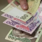 Українські гривні в руках